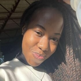 customer of Trinity Cookies - African Woman with long dark brown hair smiling